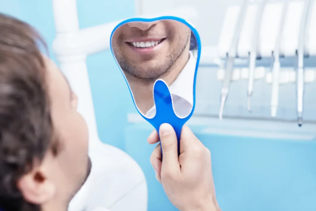 Smiling patient visiting dentist in Farmington Hills MI